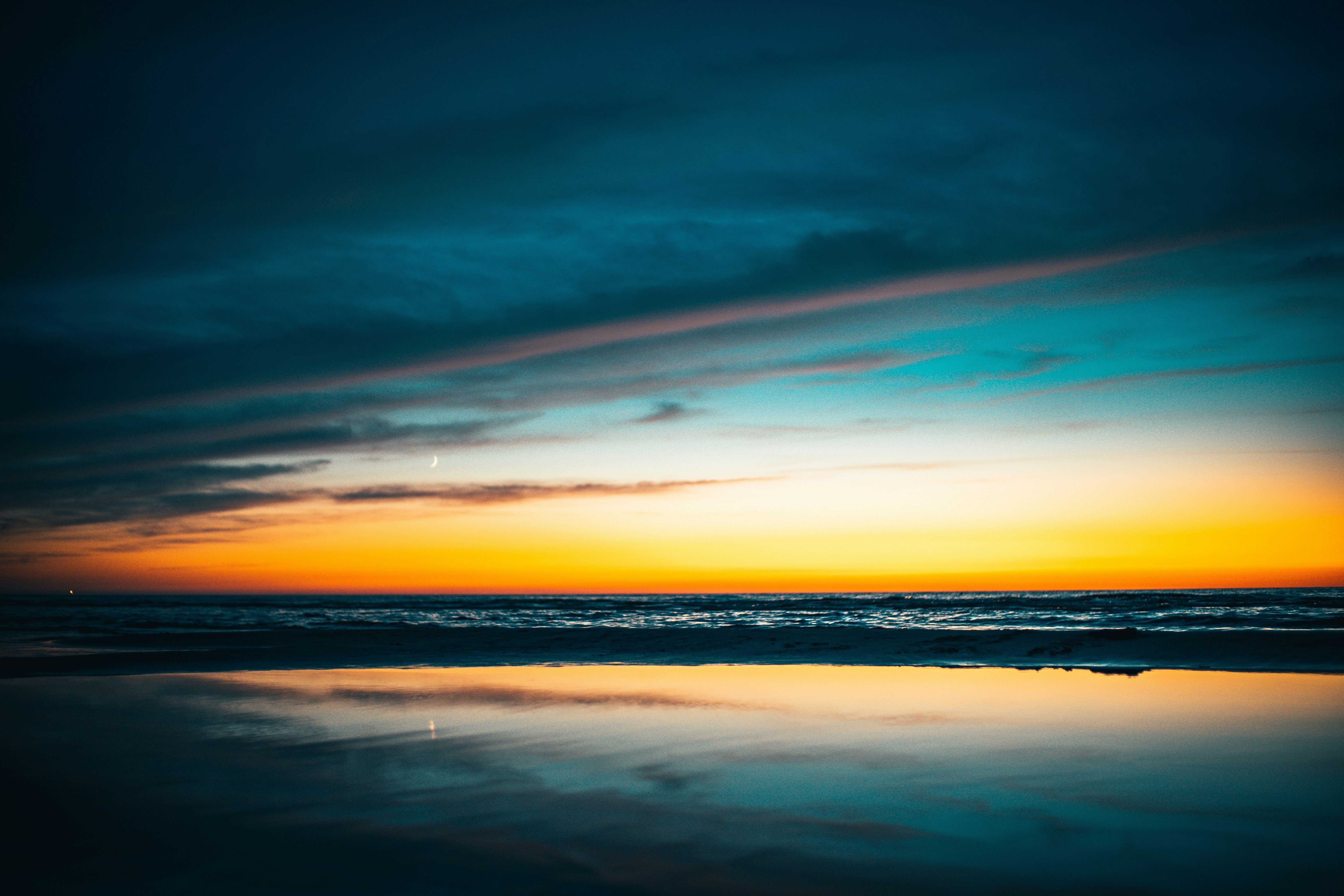 body of water under blue sky during sunset